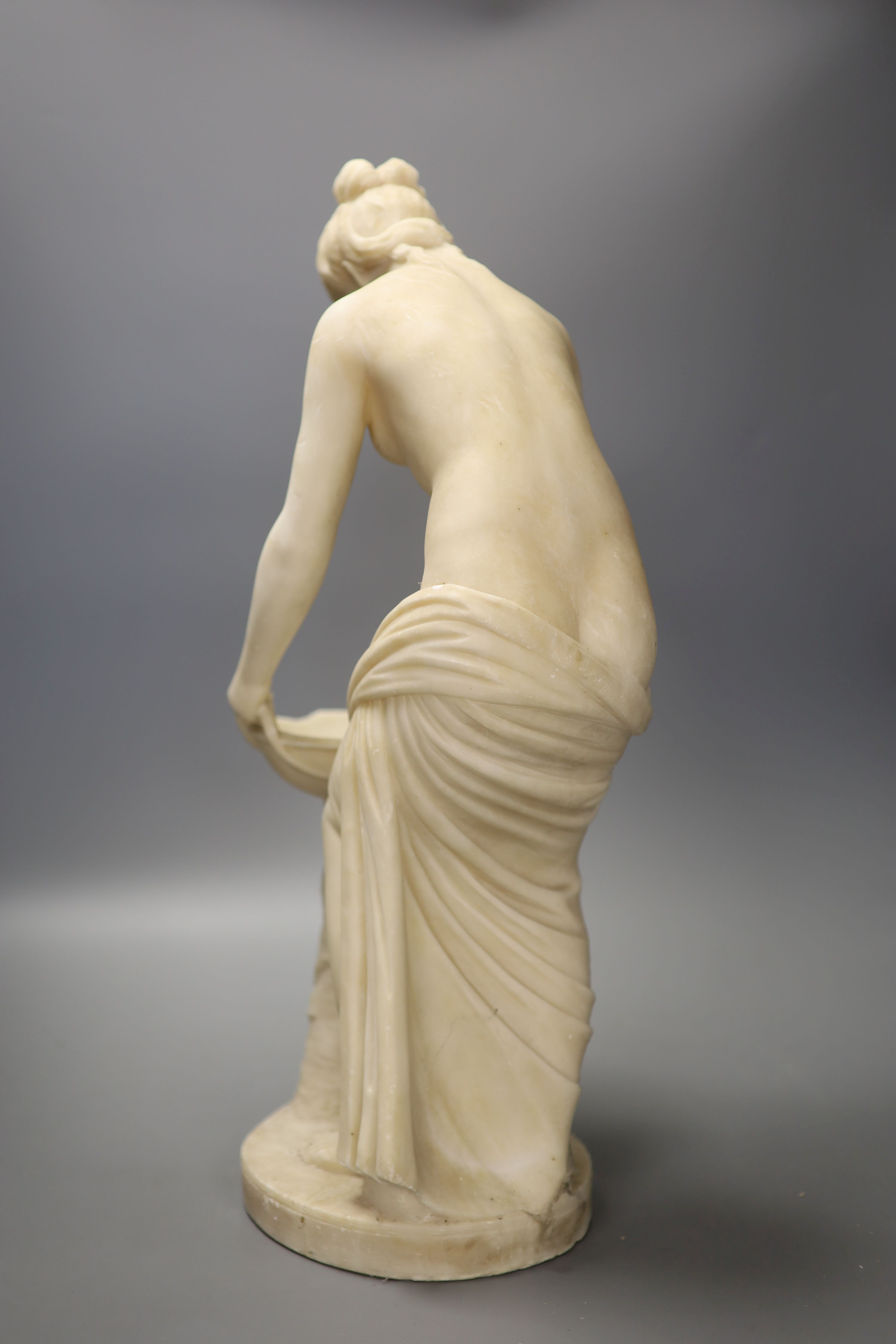 A classical alabaster figure of a water carrier, height 52.5cm